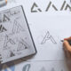 Graphic designer drawing sketch creative ideas draft logo