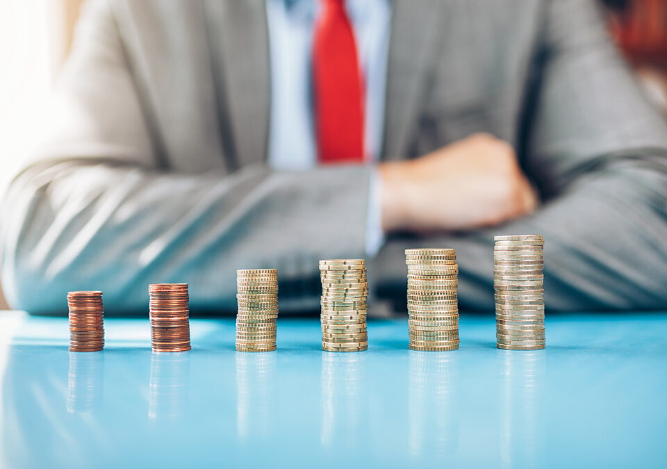 Businessman and stacked coins with financial investment concept