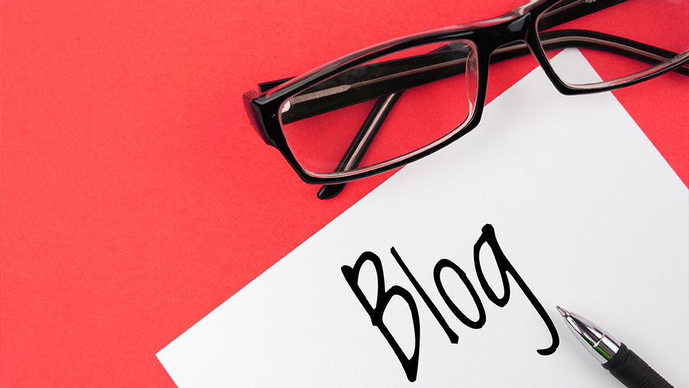 Reading glasses and blog written on the paper