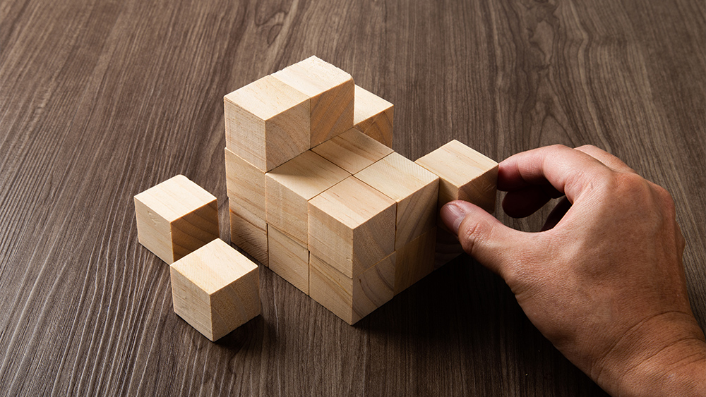 Business strategy conceptual idea human hand build with wooden cube