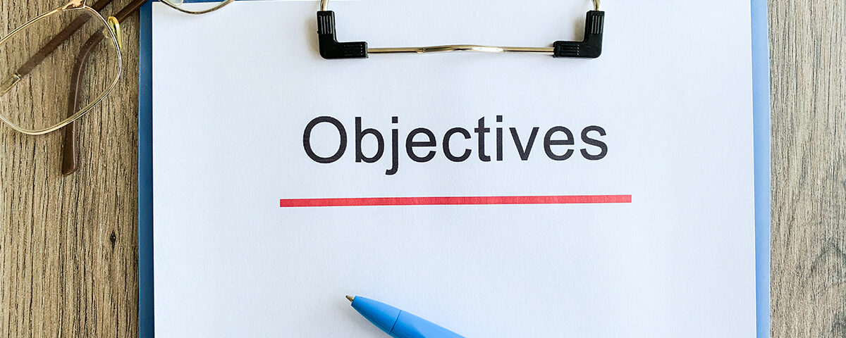 Objectives word written on a paper