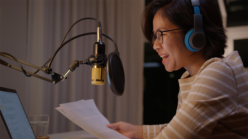 A female podcaster recording and broadcasting