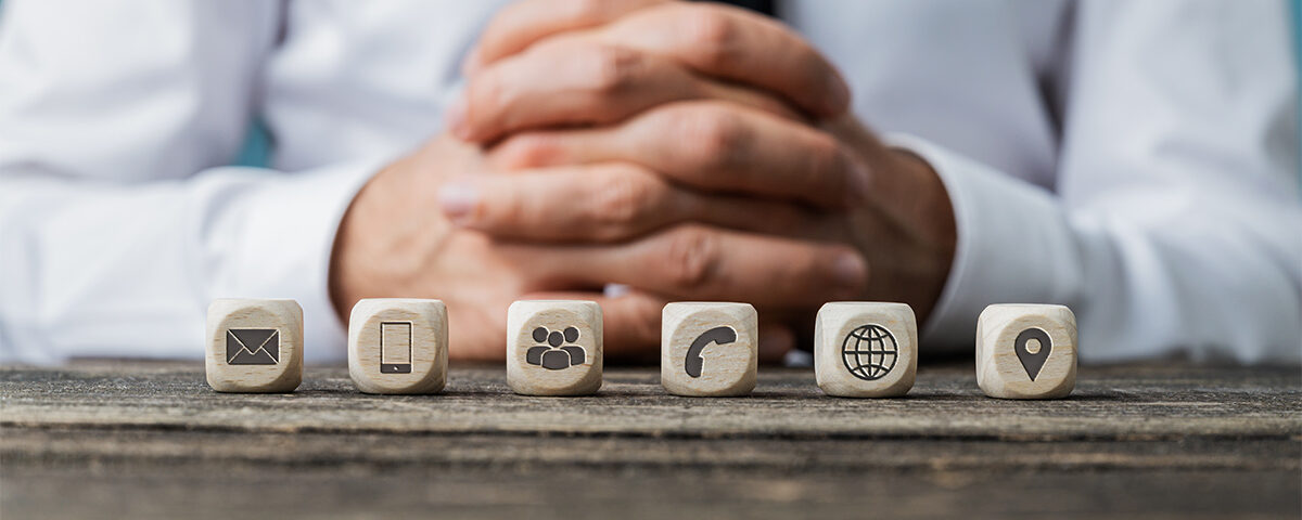 Communication ways icons on tiny wooden cubes