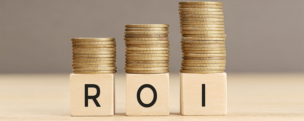ROI word in wooden blocks with coins stacked