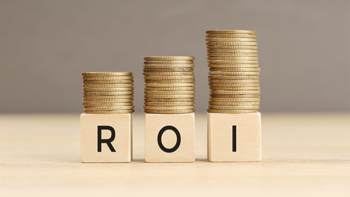 ROI word in wooden blocks with coins stacked