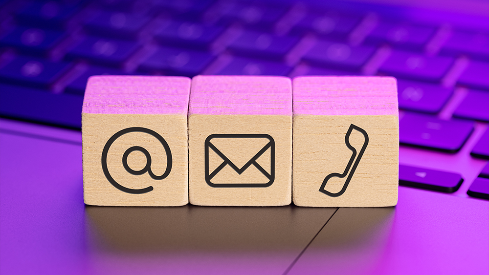 Contact us icons on wooden blocks on a laptop