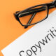 Reading glasses and blank with word copywriting