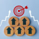 Business growth success achievement concept shown with up arrows on the wooden circles getting closer to the target sign