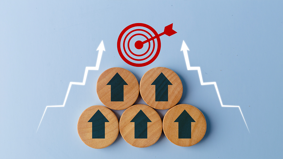 Business growth success achievement concept shown with up arrows on the wooden circles getting closer to the target sign