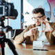 Male blogger unboxing a product in front of a camera