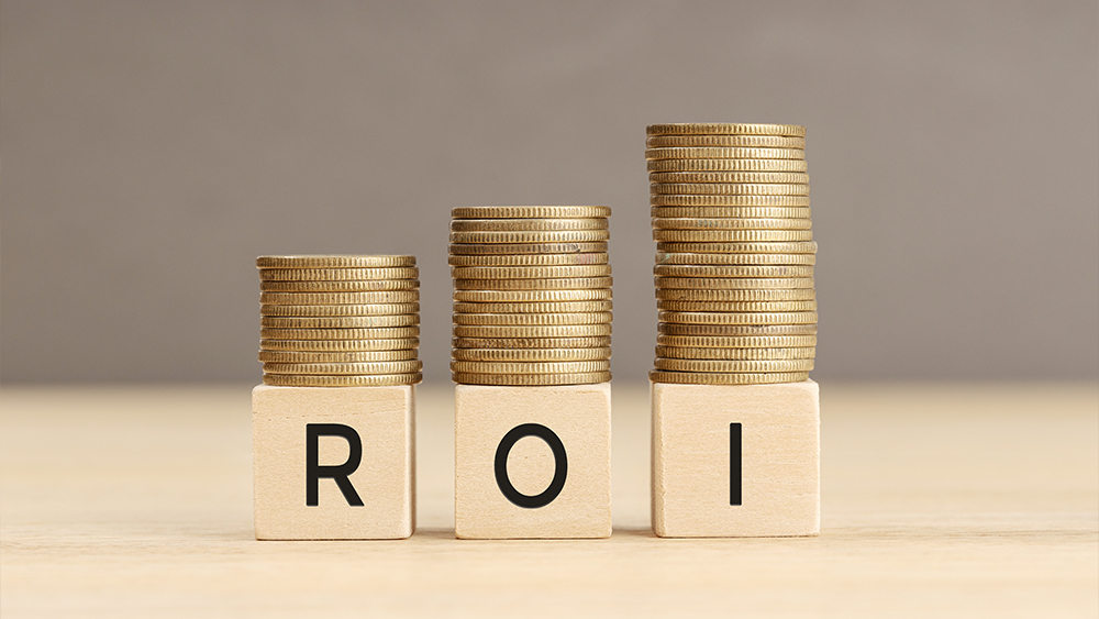 ROI word in wooden blocks with coins stacked