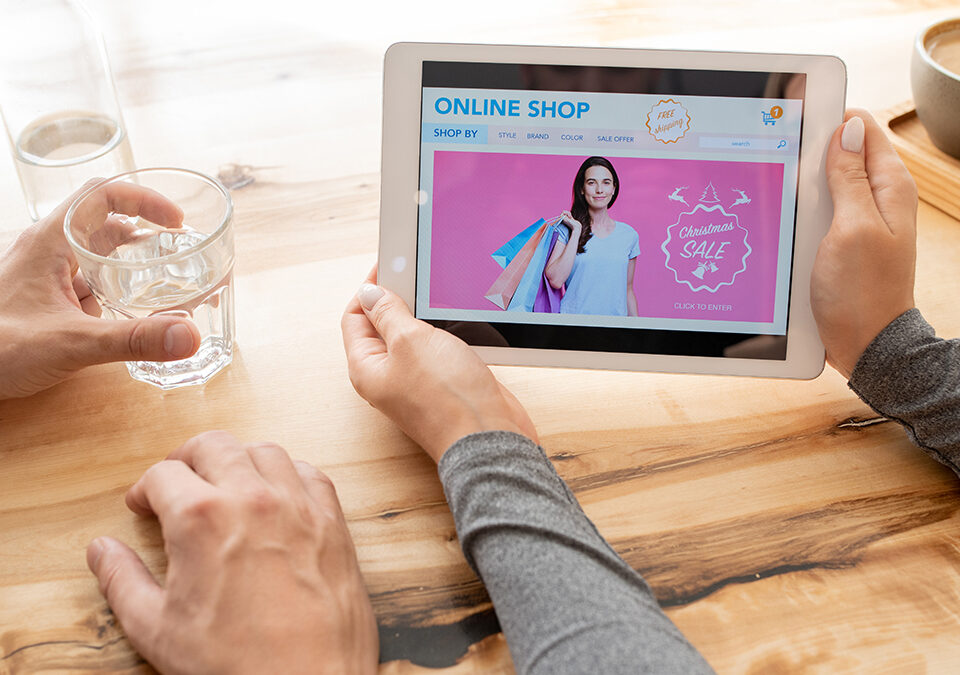 Young woman holding a digital tablet and looking at an online shop