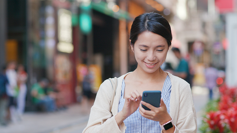 woman using mobile phone for searching location