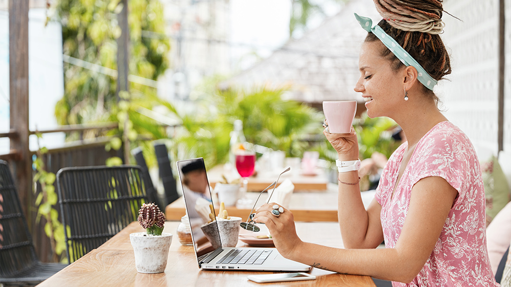 attractive female web store owner in front of laptop