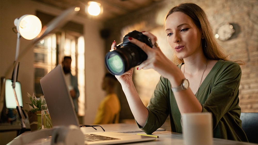 Female photographer checking images on digital camera