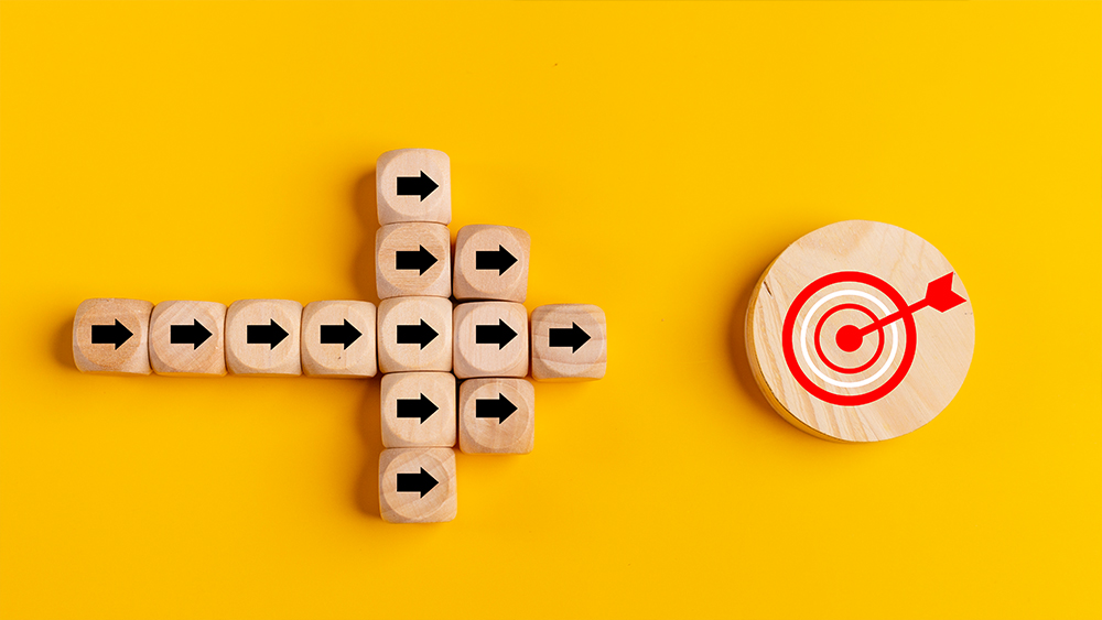 Target marketing concept with wooden blocks and arrow