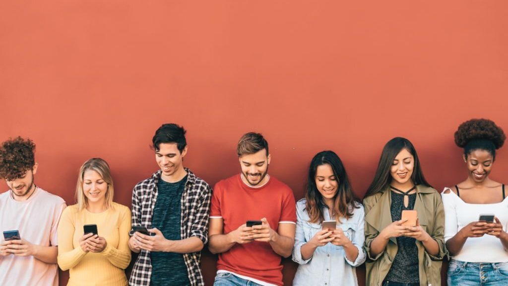 Group young people using mobile smartphone outdoor